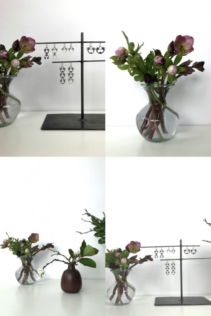 Four images showing small casual winter flower arrangements: pink hellebores in a glass vase, flowering plum branches and salal leaves in a brown bud vase, plum branches, mahonia, and huckleberry leaves, and Wraptillion's Scarab Earrings, Lotus Earrings, Small Poppy Earrings, and Large Poppy Earrings.