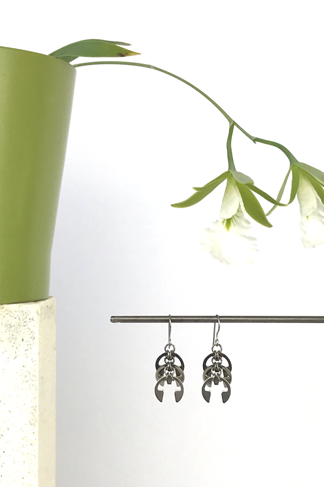 Wraptillion's Fir Cones Earrings with blooming orchid Encyclia mariae.