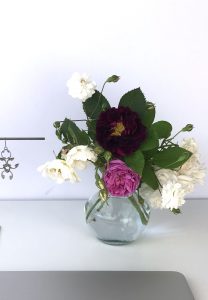 Small glass vase of old roses (Rosa alba, Rosa gallica officinalis, moss rose 'Capitaine John Ingram', & 'Felicite et Perpetue') in Wraptillion's studio.