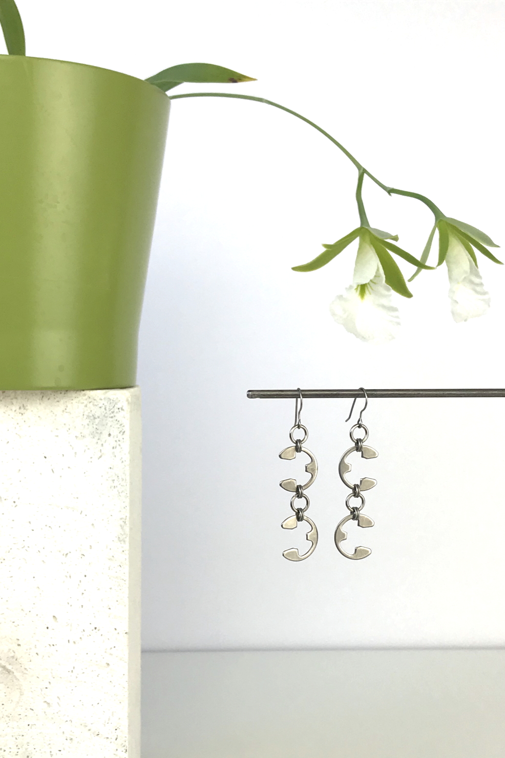 Wraptillion's Tendril Earrings with blooming orchid Encyclia mariae.