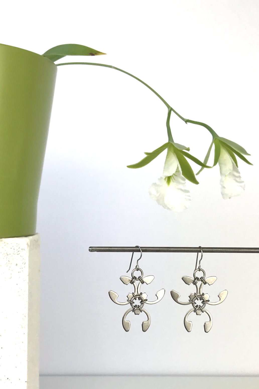 Wraptillion's Trellis Earrings with blooming orchid Encyclia mariae.