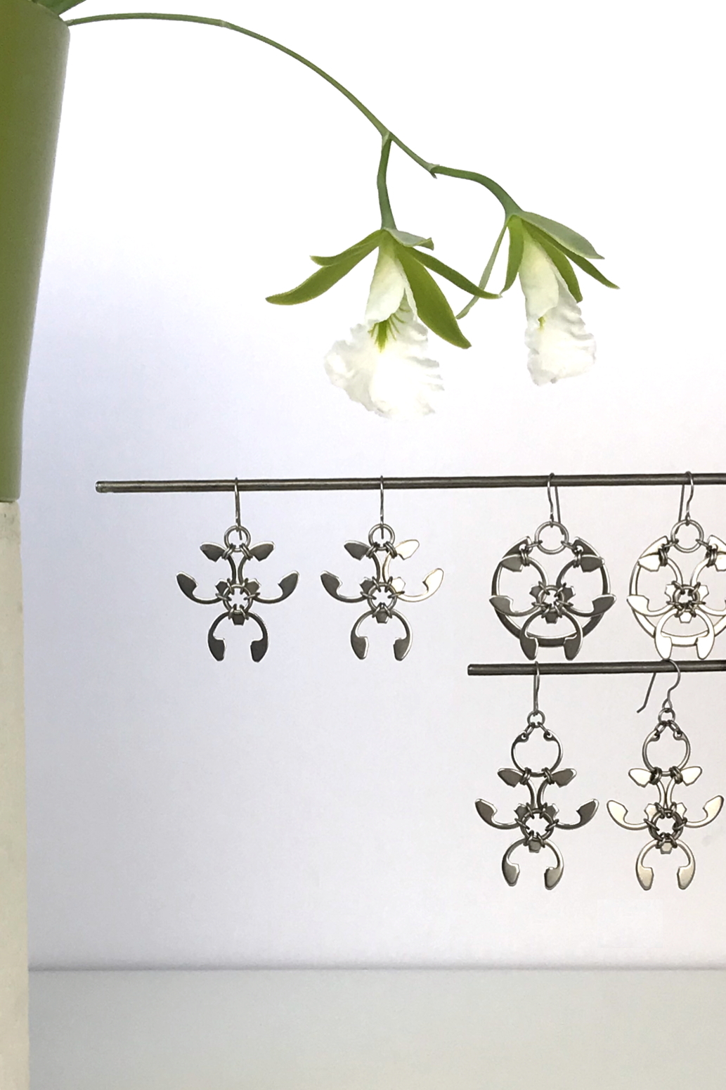 Wraptillion's Trellis Earrings, Rose Window Earrings, and Garland Earrings with blooming orchid Encyclia mariae.