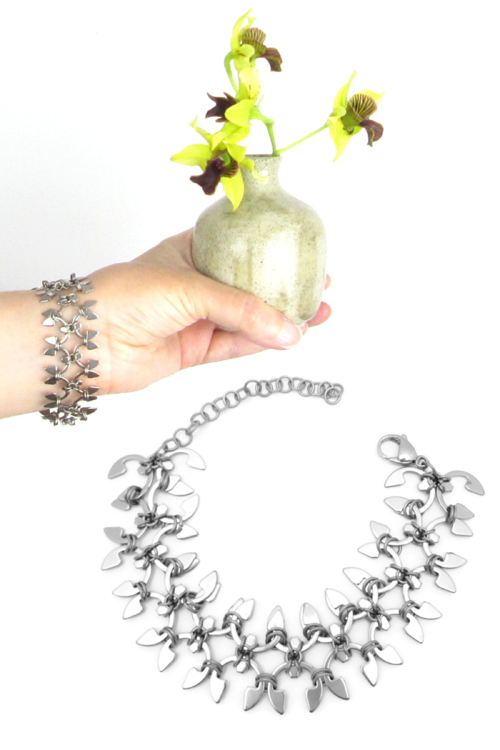 Compiled image: a hand holds a small ceramic bud vase of orchids and wears Wraptillion's Wisteria Bracelet, above a photo of the bracelet curved into a circle to show the articulated design.